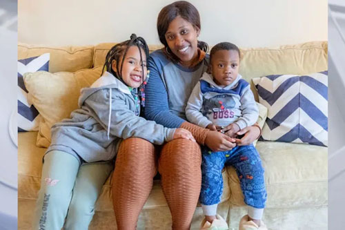 Mother sits on a couch with her kids