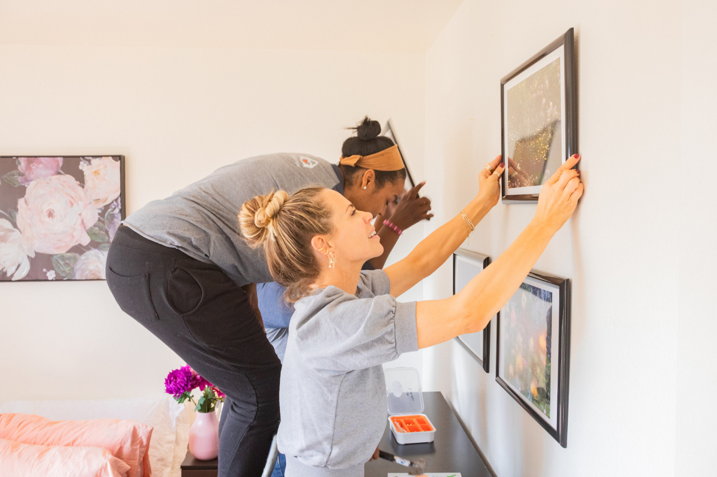 Volunteers with A Sense of Home installing art