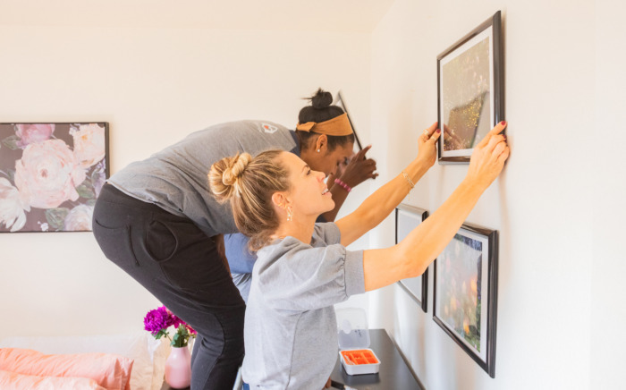 Volunteers with A Sense of Home installing art